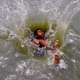 A boy jumps into a pond to cool off on a hot summer day in Agartala, India.